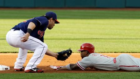 Cleveland Indians Jason Kipnis, left, tags out Philadelphia Phillies Jimmy Rollins at second base in the first inning of a baseball game on Wednesday, May 1, 2013, in Cleveland. Rollinswas trying to steal the base. (AP Photo/Tony Dejak)