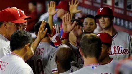 The Philadelphia Phillies celebrate their go-ahead run against the Arizona Diamondbacks during the 10th inning ...