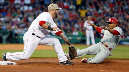 Boston Red Soxs Mike Napoli, left, puts on the tag as Philadelphia Phillies Ben Revere is doubled off first base in the third inning of a baseball game in Boston, Monday, May 27, 2013. (AP Photo/Michael Dwyer)