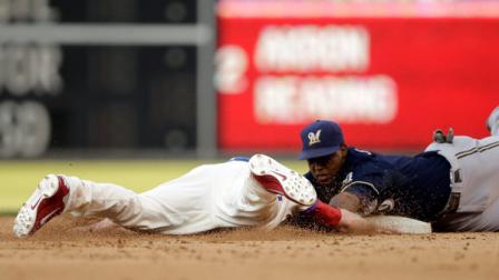 Philadelphia Phillies pinch-runner Kyle Kendrick, left, dives back to second base on a pick-off attempt as Milwaukee Brewers shortstop Jean Segura applies the tag in the ninth inning of a baseball game, Saturday, June 1, 2013, in Philadelphia. Kendrick was called out on the play. Milwaukee won 4-3.