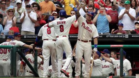Philadelphia Phillies Domonic Brown (9) celebrates with Erik Kratz, right after hitting a three run home run against the Milwaukee Brewers in the first inning of the MLB National League baseball game Sunday June 2, 2013, in Philadelphia. (AP Photo/H. Rumph Jr)