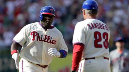 Philadelphia Phillies Ryan Howard, left celebrates with third base coach Ryne Sandberg (23) after hitting a solo home run against the New York Mets during the fourth inning of a baseball game Saturday, June 22, 2013, in Philadelphia. (AP Photo/H. Rumph Jr)