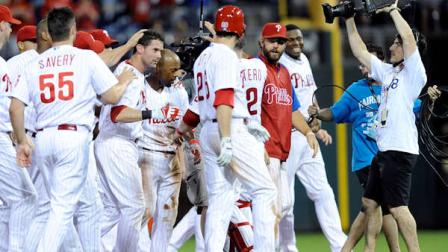 Philadelphia Phillies Jimmy Rollins celebrates with Michael Young during second baseball game of a doubleheader against the Chicago White Sox on Saturday, July 13, 2013, in Philadelphia. (AP Photo/Michael Perez)