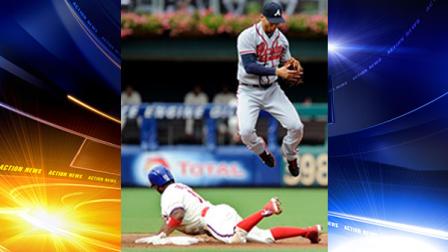 Atlanta Braves Andrelton Simmons cant handle a wild throw as Philadelphia Phillies Jimmy Rollins steals second base in the first inning of a baseball game on Saturday, Aug. 3, 2013, in Philadelphia. (AP Photo/Michael Perez)