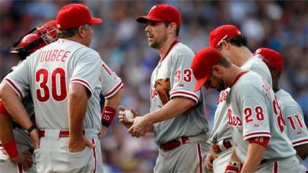 Philadelphia Phillies starting pitcher Cliff Lee 933) meets with teammates and pitching coach Rich Dubee (30) on the mound during the fourth inning of a baseball game against the Chicago Cubs on Saturday, Aug. 31, 2013, in Chicago. (AP Photo/Andrew A. Nelles)