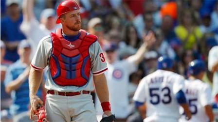 Philadelphia Phillies catcher Erik Kratz heads back to the plate after the Chicago Cubs Welington Castillo scored during the fourth inning of a baseball game on Sunday, Sept. 1, 2013, in Chicago. (AP Photo/Andrew A. Nelles)