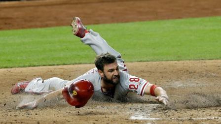 Philadelphia Phillies Kevin Frandsen (28) slides safely into home plate on a base hit by Cesar Hernandez against the Miami Marlins in the inning of a baseball game on Wednesday, Sept. 25, 2013, in Miami. (AP Photo/Alan Diaz)