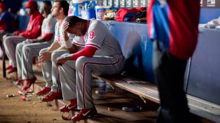Philadelphia Phillies Domonic Brown sits in the dugout after striking out in the fifth inning of a baseball game against the Atlanta Braves, Thursday, Sept. 26, 2013, in Atlanta. (AP Photo/David Goldman)