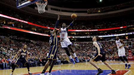Philadelphia 76ers Jrue Holiday (11) jumps for a shot against Indiana Pacers Ian Mahinmi (28) during the first half of an NBA basketball game on Saturday, March 16, 2013, in Philadelphia. (AP Photo/Matt Slocum)