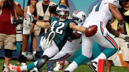 Philadelphia Eagles strong safety Kurt Coleman (42) stretches for a touchdown during the first half of an NFL football game against the Miami Dolphins, Sunday, Dec. 11, 2011, in Miami. An interception lead to the Eagles touchdown. (AP Photo/Hans Deryk)