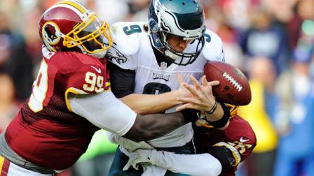 Philadelphia Eagles quarterback Nick Foles is sacked by Washington Redskins defensive end Jarvis Jenkins, left, and cornerback Josh Wilson, right, during the first half of an NFL football game in Landover, Md., Sunday, Nov. 18, 2012. (AP Photo/Nick Wass)