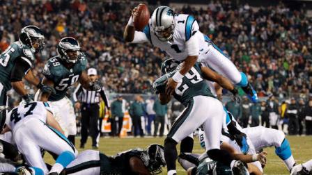Carolina Panthers quarterback Cam Newton, top, hurdles Philadelphia Eagles strong safety Nate Allen to score a touchdown in the second half of an NFL football game, Monday, Nov. 26, 2012, in Philadelphia. (AP Photo/Mel Evans)