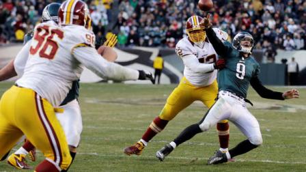 Philadelphia Eagles Nick Foles passes the ball as Washington Redskins Stephen Bowen tackles in the final seconds of an NFL football game, Sunday, Dec. 23, 2012, in Philadelphia. Foles was called for intentional grounding on the game-ending play. Washington won 27-20.