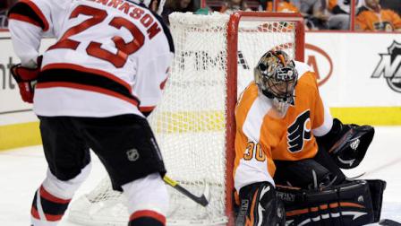 Philadelphia Flyers goalie Ilya Bryzgalov (30), of Russia, blocks a shot by New Jersey Devils David Clarkson (23) in the first period of an NHL hockey game, Tuesday, March 13, 2012, in Philadelphia. (AP Photo/Matt Slocum)