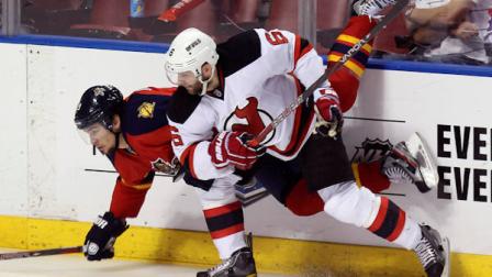 New Jersey Devils Andy Greene (6) upends Florida Panthers Scottie Upshall during the third period of Game 7 in a first-round NHL Stanley Cup playoff hockey series, in Sunrise, Fla., Wednesday, April 26, 2012. (AP Photo/J Pat Carter)