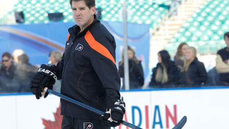 Philadelphia Flyers head coach Peter Laviolette watches his team on the ice during team practice for the Winter Classic hockey game, Sunday, Jan. 1, 2012 in Philadelphia. (AP Photo/Tom Mihalek)