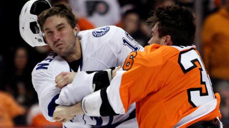 Philadelphia Flyers Zac Rinaldo, right, lands a punch that knocks the helmet off of Tampa Bay Lightning B.J. Crombeen during a fight in the first period of an NHL hockey game, Tuesday, Feb. 5, 2013, in Philadelphia. (AP Photo/Tom Mihalek)