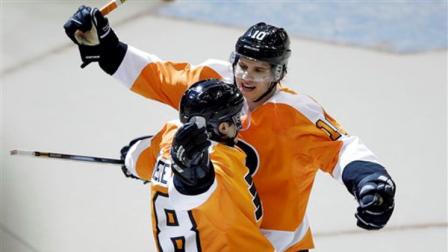 Philadelphia Flyers Danny Briere, foreground, and Brayden Schenn celebrate after Brieres game-winning goal in overtime of an NHL hockey game against the Carolina Hurricanes, Saturday, Feb. 9, 2013, in Philadelphia. Philadelphia won 4-3. (AP Photo/Matt Slocum)