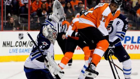 Philadelphia Flyers Wayne Simmonds, right, leaps as the puck shot by Claude Giroux gets past Winnipeg Jets goalie Ondrej Pavelec for a goal in the second period of an NHL hockey game, Saturday, Feb 23, 2013, in Philadelphia. The Flyers won 5-3. (AP Photo/Tom Mihalek)