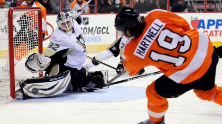 Philadelphia Flyers Scott Hartnell, right, takes a wrist shot at Pittsburgh Penguins goalie Tomas Vokoun who deflected the puck in the second period of an NHL hockey game, Thursday, March 7, 2013, in Philadelphia. (AP Photo/Tom Mihalek)
