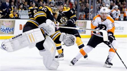 Boston Bruins Tuukka Rask (40), of Finland, comes out of the net to to play the puck as Philadelphia Flyers Ruslan Fedotenko (26), of Ukraine, closes in during the third period of an NHL hockey game in Boston, Saturday, March 9, 2013. The Bruins won 3-0. (AP Photo/Michael Dwyer)