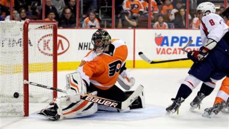 Philadelphia Flyers Ilya Bryzgalov, left, watches the puck shot by Washington Capital Alex Ovechkin, right, go wide of the net in the first period of an NHL hockey game, Sunday, March 31, 2013, in Philadelphia. (AP Photo/Tom Mihalek)