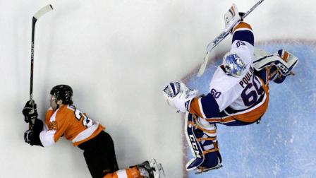 New York Islanders Kevin Poulin, right, leaps over Philadelphia Flyers Claude Giroux in the second period of an NHL hockey game, Thursday, April 25, 2013, in Philadelphia. (AP Photo/Matt Slocum)