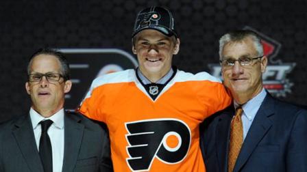 Samuel Morin, a defenseman, stands with officials from the Philadelphia Flyers sweater after being chosen 11th overall in the first round of the NHL hockey draft, Sunday, June 30, 2013, in Newark, N.J. (AP Photo/Bill Kostroun)