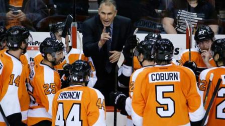 Philadelphia Flyers coach Craig Berube, center, talks to his team during a timeout in the third period of an NHL hockey game against the Florida Panthers, Tuesday, Oct. 8, 2013, in Philadelphia. Philadelphia won 2-1. (AP Photo/Matt Slocum)