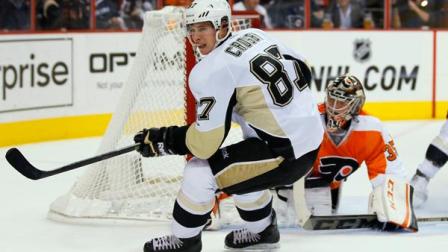 Pittsburgh Penguins Sidney Crosby, left, turns toward the loose puck turned away by Philadelphia Flyers goalie Steve Mason, rear, in the first period of an NHL hockey game, Thursday, Oct. 17, 2013, in Philadelphia. (AP Photo/Tom Mihalek)