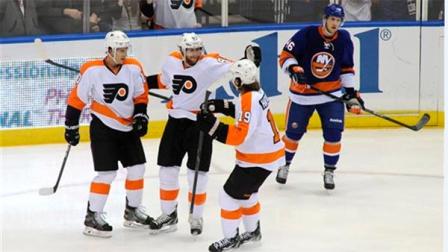 Philadelphia Flyers Brayden Schenn (10), Jakub Voracek (93) and Scott Hartnell (19) celebrate Voraceks goal as New York Islanders Matt Donovan (46) reacts in the first period of an NHL hockey game at the Nassau Coliseum on Saturday, Oct. 26, 2013, in Uniondale, N.Y. (AP Photo/Kathy Kmonicek)