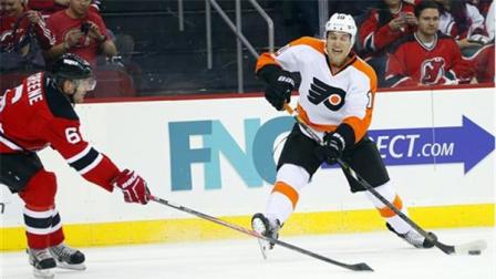 Philadelphia Flyers Brayden Schenn (10) takes a shot as New Jersey Devils Andy Greene (6) defends during the first period of an NHL hockey game in Newark, N.J., Saturday, Nov. 2, 2013. (AP Photo/Rich Schultz)