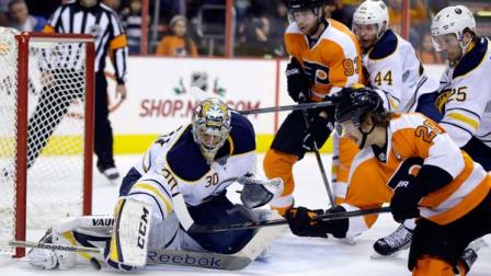 Buffalo Sabres Ryan Miller (30) blocks a shot by Philadelphia Flyers Claude Giroux (28) as Jakub Voracek (93), of Czech Republic, Brayden McNabb (44) and Mikhail Grigorenko (25), of Russia, stand by during the second period of an NHL hockey game Thursday, Nov. 21, 2013, in Philadelphia. (AP Photo/Matt Slocum)