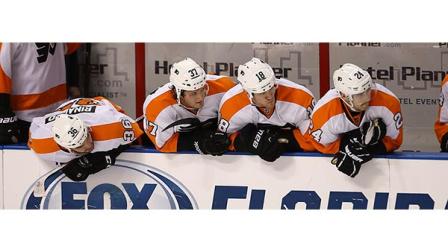 Philadephia Flyers players Zac Rinaldo (36), Jay Rosehill (37), Adam Hall (18) and Matt Read (24) watch game action in the final minutes of the NHL hockey game in Sunrise, Fla., Monday, Nov. 25, 2013 against the Philadephia Flyers. The Panthers won 3-1. (AP Photo/J Pat Carter)