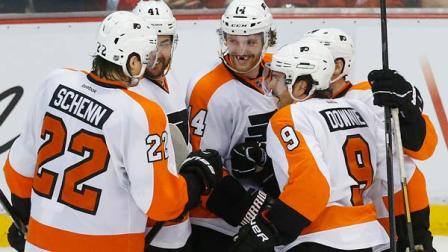 Philadelphia Flyers center Sean Couturier (14) celebrates his goal against the Detroit Red Wings with teammates in the third period of an NHL hockey game in Detroit, Wednesday, Dec. 4, 2013. (AP Photo/Paul Sancya)