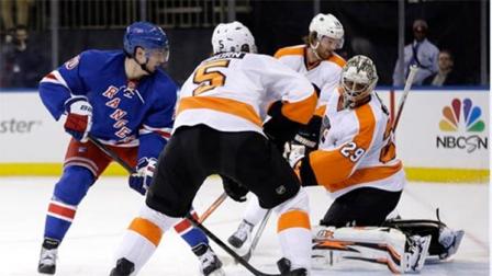 New York Rangers Chris Kreider, left, watches as his shot gets past Philadelphia Flyers goalie Ray Emery, right, and Philadelphia Flyers Braydon Coburn (5) during the second period of the NHL hockey game Sunday, Jan. 12, 2014, in New York. (AP Photo/Seth Wenig)