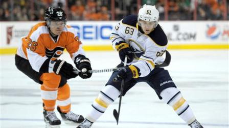 Buffalo Sabres Tyler Ennis (63) bring the puck past Philadelphia Flyers Ruslan Fedotenko (26), of Ukraine, in the first period of an NHL hockey game, Sunday, March 10, 2013, in Philadelphia. (AP Photo/Michael Perez)