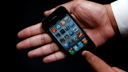 An Associated Press reporter holds the Apple iPhone during a product test review in San Francisco, Thursday, June 24, 2010.