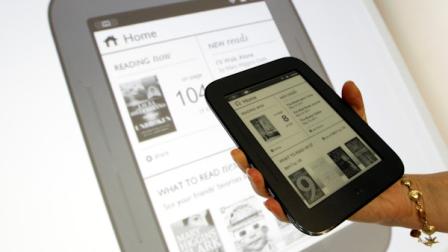 A product specialist holds up a new Nook during a news conference Tuesday, May 24, 2011, in New York. The new Nook features a black-and-white touch screen and aims squarely at the grandma demographic.(AP Photo/Mary Altaffer)