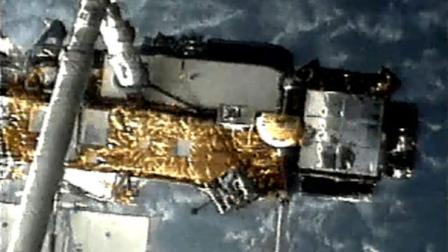 This screen grab image provided by NASA shows UARS attached to the robotic arm of the space shuttle Discovery during mission STS-48 in 1991, when UARS was deployed. NASA scientists are doing their best to tell us where a plummeting 6-ton satellite will fall later this week. Its just that if theyre off a little bit, it could mean the difference between hitting Florida or New York. Or, say, Iran or India. (AP Photo/NASA)