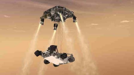 In this 2011 artists rendering provided by NASA/JPL-Caltech, a sky crane lowers the Mars Science Laboratory Curiosity rover onto the surface of Mars. The mobile robot is designed to investigate Mars past or present ability to sustain microbial life.