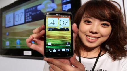 A model displays HTC One X during a press conference in Taipei, Taiwan, Sunday, March 26, 2012. HTC Corp. is marketing the new smartphone that can take four digital photos per second, a model the Taiwan maker hopes can help reverse its falling revenue amid keener competition.