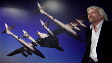 Richard Branson, founder of the Branson Group, talks during an interview, Thursday, Dec. 1, 2011 in his companys New York office. Branson is promoting his book, Screw Business as Usual. On the wall is a photograph of White Knight II, an aircraft built by Virgin Galactic.