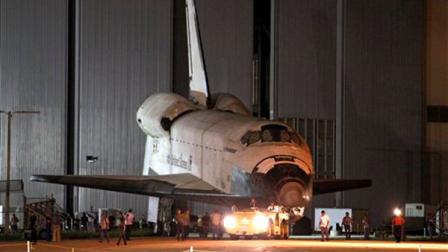 Space shuttle Endeavour is towed to the Kennedy Space Center landing facility where it will be mounted on a modified jumbo jet, Friday, Sept. 14, 2012, in Cape Canaveral, Fla. On Monday morning, Endeavour will make a four-day trip to Los Angeles atop the jumbo jet bound for the California Science Center.(AP Photo/John Raoux)