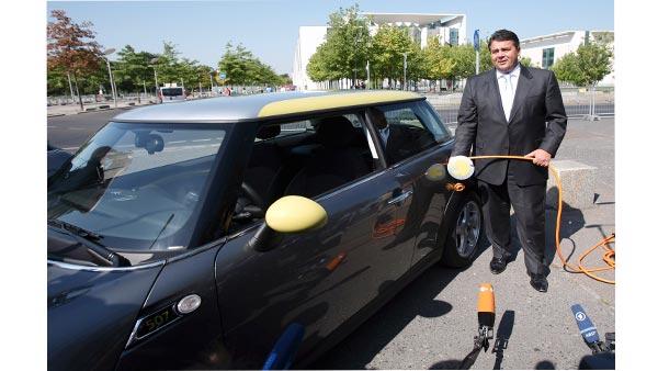 German Environment Minister Sigmar Gabriel poses for the media with a Mini electric automobile in Berlin, Germany, Wednesday, Aug. 19, 2009. Germany launched a campaign Wednesday to put 1 million electric cars on the road by 2020, making battery research a priority as it tries to position the country as a market leader. (AP Photo/Maya Hitij)