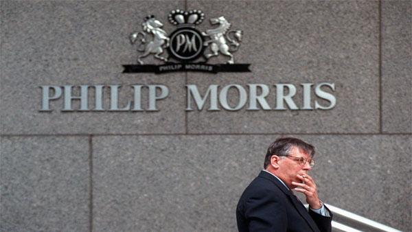 An unidentified man take a cigarette break outside the headquarters of Philip Morris in New York, Wednesday, May 15, 1996. Philip Morris is one company who sells tobacco-related products. (AP Photo/File,Chris Kasson)