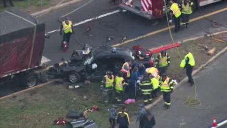 Rescue teams work to get a trapped person out of a car that crashed along the New Jersey Turnpike early Thursday morning.