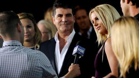 The X Factor judges Simon Cowell and Britney Spears attend the FOX network upfront presentation party at Wollman Rink, Monday, May 14, 2012 in New York. (AP Photo/Evan Agostini)