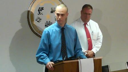 Officer John Taylor speaks with reporters Monday