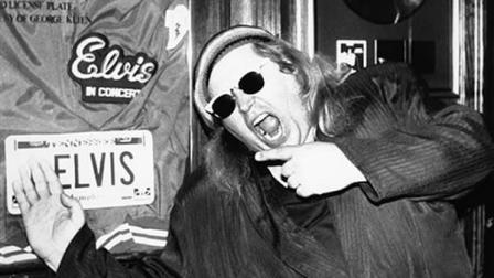 FILE - In this June 10, 1988 file photo, comedian Sam Kinison, known for his bellowed outbursts, poses at New Yorks Hard Rock Cafe where he was filming a promo for MTV.